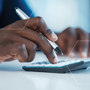 Picture of man's hand using calculator and holding a pen