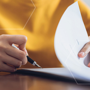 Picture of person writing on paper with pen